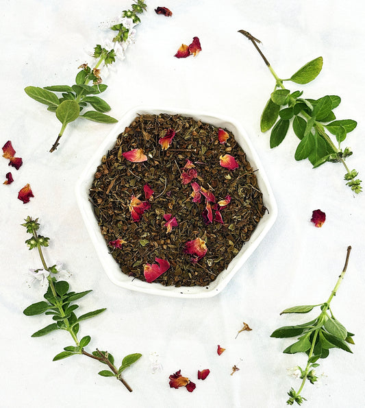 Chai Street Tulsi herbal tea blend in a bowl with rose petals and tulsi leaves on a white background