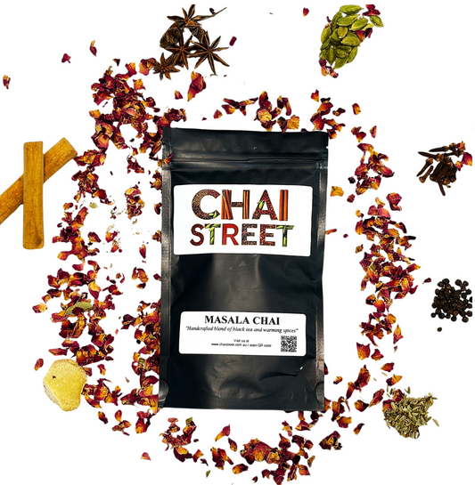 Chai Street Masala Chai pack surrounded by traditional Indian spices like cinnamon, cardamom, cloves, and dried rose petals
